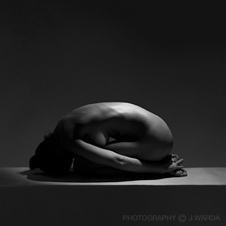naked female body crouching on floor photography by j.warda fine art nude photography